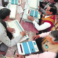 Poll officials check EVMs in Jaunpur, Uttar Pradesh, on Tuesday. 