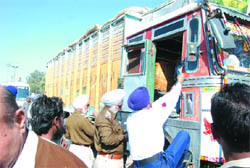 A traffic cop climbs a truck to check the use of pressure horns during the ongoing drive in the city. Heavy vehicle owners are being advised not to use pressure horns.
