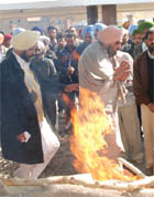 The mortal remains of Pritpal Singh Bhinder (below right) being consigned to flames.