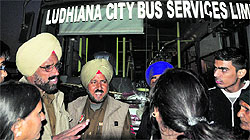 Police officials try to pacify passengers who charged the bus driver and conductor with misconduct near the Jalandhar bypass, Ludhiana, on Wednesday