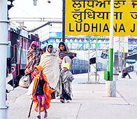 A family walks on a platform at the Ludhiana railway station on a chilly Wednesday morning