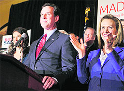 US Republican presidential candidate Rick Santorum with his wife Karen speaks at his primary night rally in Missouri