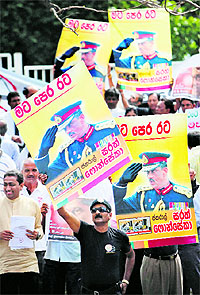 Opposition lawmakers display placards in front of the SC complex urging the government to release jailed ex-army chief-turned-presidential candidate Sarath Fonseka in Colombo on Wednesday