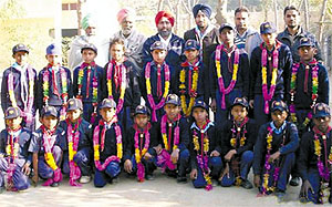 The students pose with their teachers for a photo call in their school in Giana on Thursday
