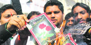 Activists of the Hindu Shiv Sena burn greeting cards to protest against Valentine's Day celebrations in Jammu on Thursday.