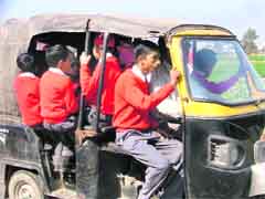 Schoolchildren being ferried in an overloaded auto-rickshaw in violation of the High Court orders.