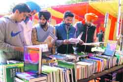 Students at a stall selling books on technical subjects at a book fair on the PAU campus.
