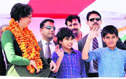 Priyanka Gandhi Vadra with her kids at a rally in Amethi on Thursday. 