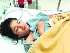 Diya, who was injured when a pillar of a building fell over her, undergoes treatment at a private hospital in Amritsar on Friday. 