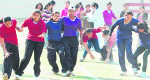 Students participate in the three-leg race during the annual sports meet of the BBK DAV College for Women in Amritsar on Friday. 