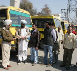 A cop checks the documents of a school vehicle in Bathinda. 