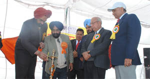 Dignitaries light the ceremonial lamp at the inaugural ceremony of the Kala Mela at the Malwa College in Bathinda on Friday. 