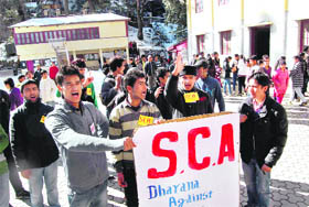 Students hold a protest against the proposed fee hike at Sanjauli college in Shimla on Friday.