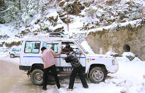 A vehicle stuck on a slippery road near the IGMC in Shimla on Friday.