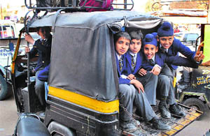 An auto-rickshaw overloaded with students in Patiala. 