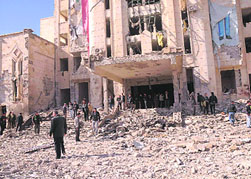 Syrian security personnel inspect the site of an explosion in Aleppo on Friday.
