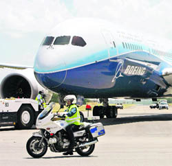 Boeings new midsize passenger airplane, the 787 Dreamliner, is towed on the runway at after touching down at a military airbase ahead of its exhibition at the Singapore Airshow on Saturday. The aviation trade event takes place from February 14 to 19.