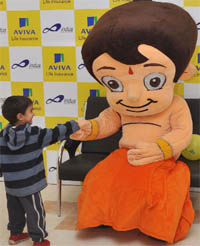 A child shakes hands with Chhota Bheem during a function at Indus World School in Gurgaon on Saturday. 