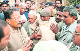 Chief Minister BC Khanduri meets next of kin of the victims of a fire incident at a factory at Mangalore near Roorkee on Saturday.