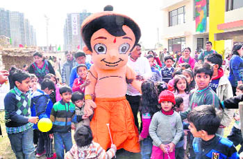 A man dressed up as Chhota Bheem entertains children at Indus World School in Gurgaon on Saturday. 