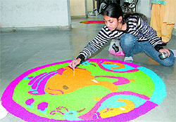 A college student makes rangoli during Synergy-2012, an inter-college competition, held at Lyallpur Khalsa College, Jalandhar, on Saturday