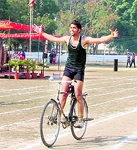 An athlete in a cheerful mood after emerging winner in the 4,800m cycling race at SCD College in Ludhiana