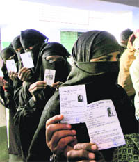 Women voters queue up at a polling station in Azamgarh on Saturday. 