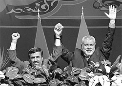 Iranian President Mahmoud Ahmadinejad (left) and Gaza's Hamas Prime Minister Ismail Haniyeh gesture at a rally in Tehran on Saturday