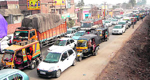Vehicles stuck in a traffic jam on the Taranwala bridge in Amritsar on Sunday.