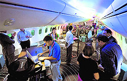 Press members and Boeing officials tour the interior of a Boeing 787 Dreamliner during a press preview in Singapore on Sunday. Boeing 787 Dreamliner is here for the Singapore Airshow 2012 as part of their Dream Tour 2011-2012