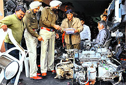 Police officials check engine numbers of vehicles during a raid to trace unverified vehicles in Kabbari Market, Sector 45, Chandigarh, on Sunday