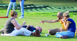 Foreign visitors on the lawns of India Gate in New Delhi on Sunday
