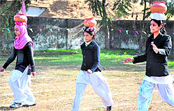 Students of Kanya Gurukul Mahavidyalaya take part in a clay pot fun race in Haridwar