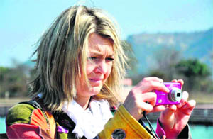A foreigner clicks a photograph in Haridwar on Sunday. 
