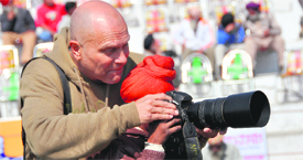 Ken, a photographer from Norway, teaches photography skills to a boy