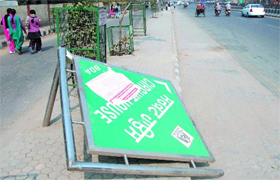 A board indicating the direction of the Circuit House is seen lying on the road near the Mini-secretariat on Monday even as the mandarins in the civic body seem unaware of it.