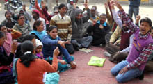 Hospital staff staging protest at Civil Hospital in Gidderbaha on Monday. 