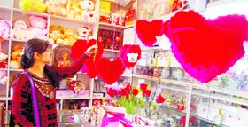 A girl selects a gift on the eve of Valentines Day at a shop in Dharamsala on Monday.
