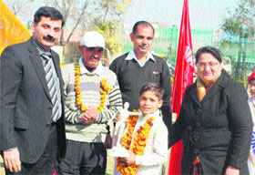 Ashish Arya, chairman of Little Angels School, Sonepat, (left) and Sonia Arya, director of the school, welcome Sagar and his father Surender Dahiya in Sonepat. 