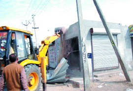 A team from the Municipal Corporation Bathinda removing unauthorised structures in the city on Tuesday. 