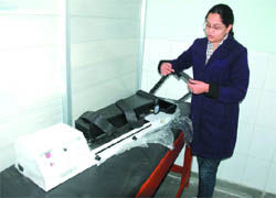 Physiotherapist Amanpreet Kaur with a machine to be installed at the new unit in the OPD block of the Civil Hospital on Tuesday. 