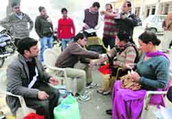 Health officials take blood samples during screening operations for hepatitis C in Ratia town of Fatehabad district