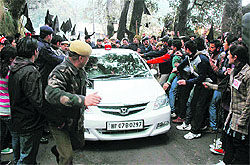 SFI activists obstruct the Vice-Chancellors vehicle in protest against the proposed fee hike at Himachal Pradesh University in Shimla on Tuesday