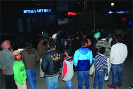 People gather at the site outside the Mittals Mall where a brawl took place on Wednesday evening. 