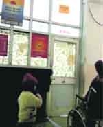 An old woman waits in a wheelchair outside the closed geriatric OPD of the GMCH at Sector 32 in Chandigarh