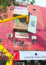 Hoardings being removed during a drive at Sector 17 in Chandigarh
