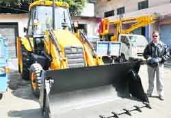 A new JCB machine that is lying unused and unregistered on the Dehradun Municipal Corporation premises.
