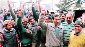 Taxi operators raise slogans against an increase in the token tax outside the RTO office in Shimla on Wednesday.