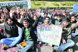 Volunteers of the National Youth Corps stage a protest in support of their demands in Jammu on Wednesday.