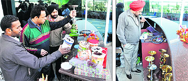 Food Safety Officer Manoj Khosla (in green sweater) inspects a hukkah at a bar in Ludhiana on Wednesday; and (right) District Health Officer Kulwinder Singh smells a pipe